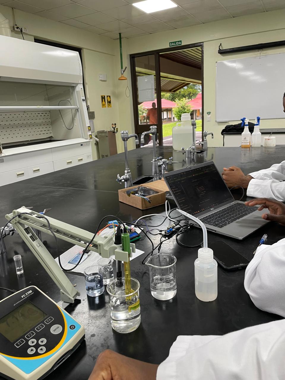 Lab bench with pH meter, beakers, and Arduino prototype